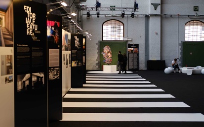 Brussels expo event hall with black and white striped carpet pathway