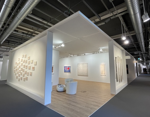white painting exhibition room inside big event hall with black carpet pathway