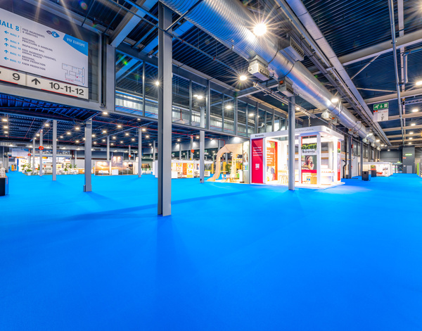 inside of VIV Europe at Jaarbeurs Utrecht event hall with aqua blue recyclable carpeting between small booths